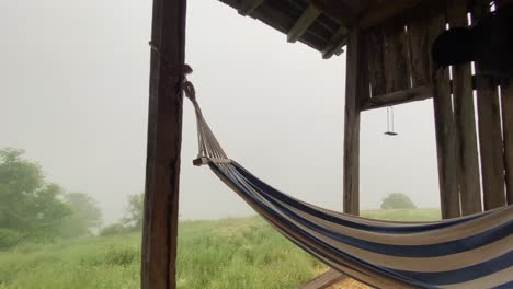 Hanging-Hammock---Wooden-Swing-in-a-Relaxing-Summer-House-Cottage-Terrace,-in-a-Foggy-Day-in-Nature
