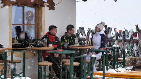 Friends-at-ski-resort-bar-during-snowfall