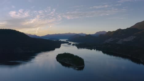 Misty-river-and-mountains-of-Canada-during-sunset---aerial