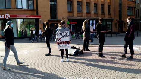Group-of-young-women-protesting-in-Riga-against-animal-cruelty,-static,-day