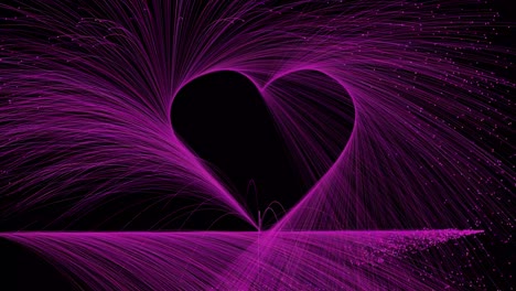 Pink-particles-trace-out-a-love-heart-on-a-black-background---can-be-looped,-copy-space-for-your-message