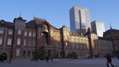 Little-Sunlight-Striking-On-Tokyo-Station-In-Japan-With-High-Rise-Buildings-Behind-Before-Sunset---Wide-Shot