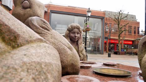 Mad-hatter-tea-party-granite-carved-sculpture-in-Warrington-town-Golden-square-Slow-left-dolly