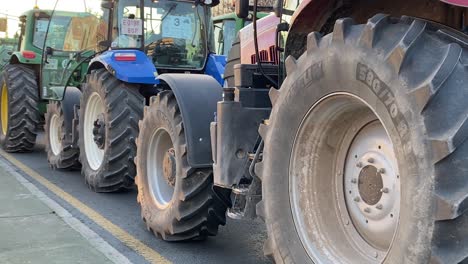 Pan-shot-of-the-wheels-of-many-tractors-in-a-protest
