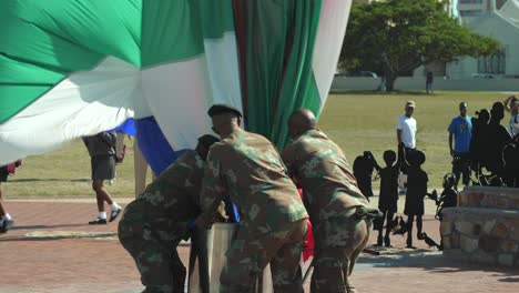 Slow-motion-shot-of-the-South-African-Army-lowering-the-national-flag-into-a-container,-a-daily-ritual-in-Port-Elizabeth,-Nelson-Mandela-Bay