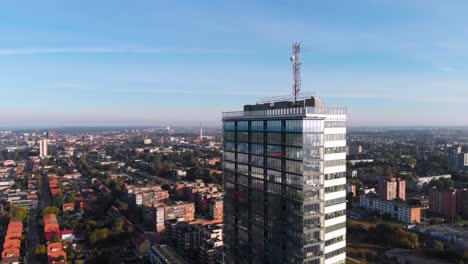 The-drone-flies-towards-the-building,-it-is-the-largest-building-in-Klaipeda