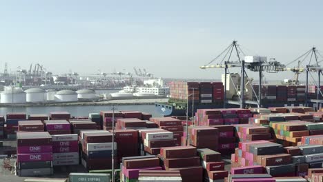 Aerial,-Long-Beach-harbor-over-freight-of-cargo,-shipping-cranes
