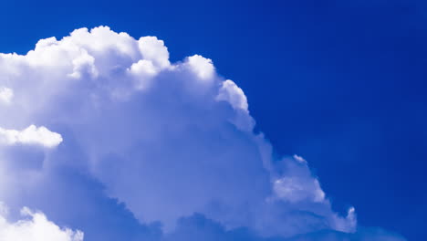 Fluffy-clouds-silver-lining-on-vivid-polarised-blue-sky-background,-copy-space
