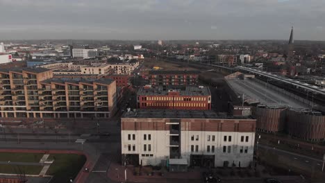 Aerial-view-over-the-Het-Koelhuis-building,-formerly-a-butter-warehouse-in-the-Noorderhaven-neighbourhood-where-on-top-a-rooftop-terrace-is-planned-as-a-central-point-in-the-new-residential-area