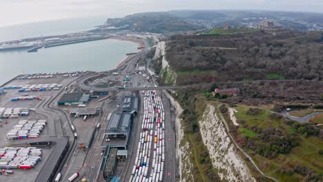 Aerial-drone-shot-of-trucks-queueing-to-leave-the-UK-at-dover-to-calais-harbour-brexit