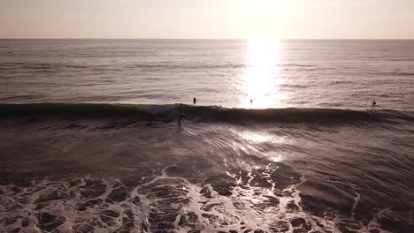 Bright-Sunlight-Falling-On-Sea-Surface-With-Tourist-Surfers-In-Olon-Beach,-Ecuador