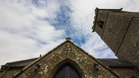 Time-lapse-of-a-historical-medieval-church-with-entrance-door-and-tower-in-rural-Ireland-during-the-day-with-passing-clouds-in-the-sky