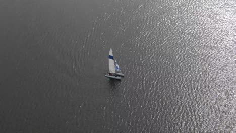 Segelboot-In-Der-Mitte-Eines-Sees-Oder-Ozeans,-4K-Drohnenaufnahmen