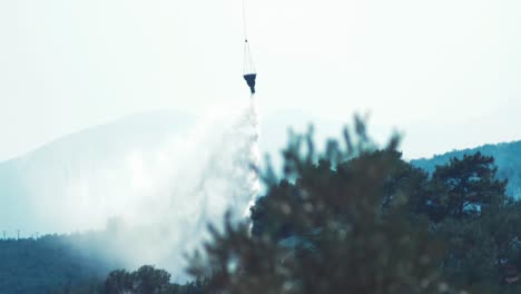 Helicopter-flying-to-forest-fire-dropping-water