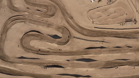 Birds-Eye-View-of-motocross-racing-circuit-in-California-Mojave-Desert,-AERIAL