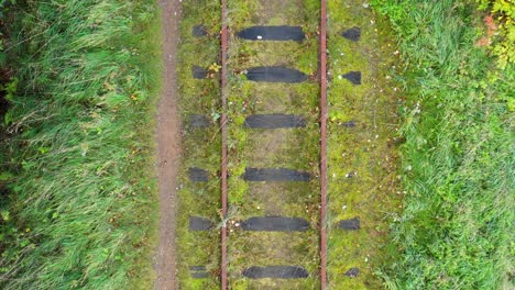 Birds-eye-view-following-old-rusty-abandoned-rail-tracks