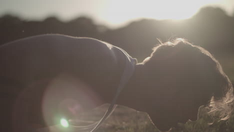 Close-Up-Shot-of-Young-Attractive-Man-Doing-Push-Ups-In-The-Park-During-Golden-Hour---Ungraded
