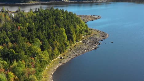 Aerial-footage-of-remote-lake-in-northern-Maine-after-a-dry-summer-DOLLY-ZOOM-towards-rocky-peninsula