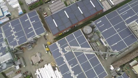 Drone-lifting-up-over-industrial-roof-with-solar-panels
