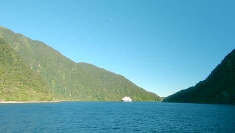 Wide-shot-of-a-cruise-ship-entering-a-fiord,-Milford-Sound,-New-Zealand