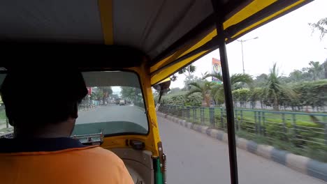 Inside-of-auto-rickshaw-or-tuktuk-traveling-in-Indian-or-Asian-traffic,-Pov-of-backseat-passengers