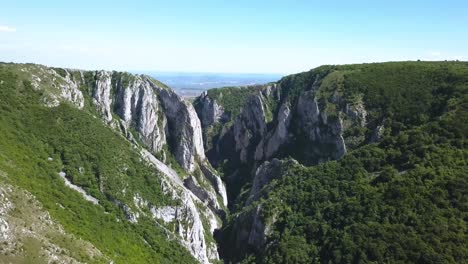Drone-flying-backwards-reveals-the-amazing-view-of-the-top-of-Turda-Gorge-and-the-landscape-beyond-on-the-horizon