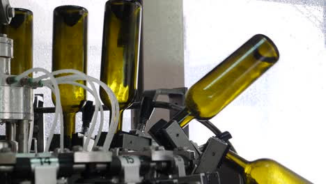 Extreme-close-up-wine-bottles-are-sanitized-in-industrial-machines-at-the-wine-bottling-factory
