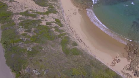 Aerial-view-above-seagulls-of-cliff-down-to-ocean-at-Point-Nepean