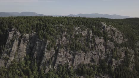 Aerial-Drone-Shot-Panning-Across-Forest-On-Mountain-Side