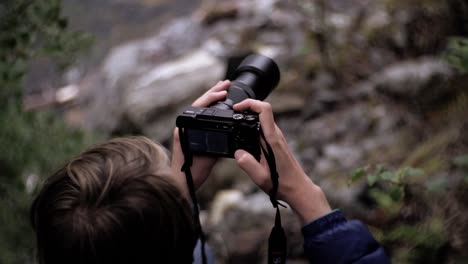 Man-handling-camera-in-nature-environment,-slow-motion,-Norway,-Europe