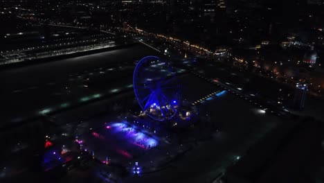 Aerial-clip-of-a-Ferris-Wheel-during-the-night-in-Montreal,-Canada