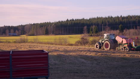 Tractor,-harvesting-on-a-wheat-field,-on-the-countryside,-on-a-sunny,-autumn-evening,-in-Soderhamn,-Sweden
