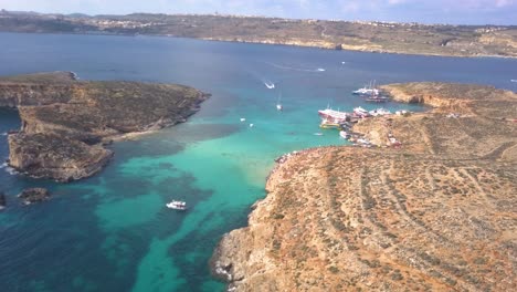 Blue-Lagoon,-made-famous-by-the-movie,-just-off-the-coast-of-Comino-Island-is-a-favorite-tourist-destination-for-swimming,-snorkeling-and-diving-while-visiting-Malta
