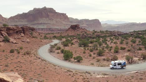 Slow-motion-shot-of-motorhome-driving-on-beautiful-road-in-Capitol-Reef-National-Park-in-Utah,-USA