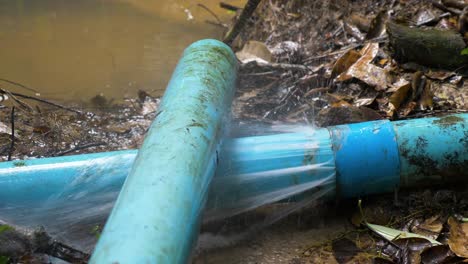 Old-blue-PVC-pipes-leaking-water