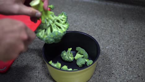 Cutting-Healthy-Green-Organic-Raw-Broccoli-Florets-for-Boiling-in-Water