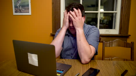 Man-very-stressed-out-about-something-on-his-laptop-computer