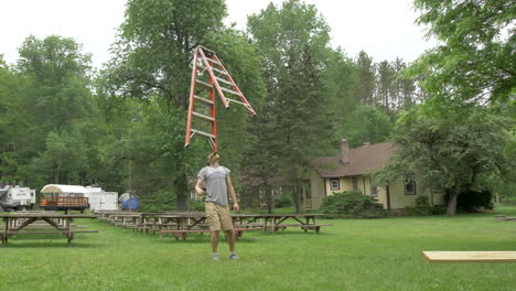 A-Man-Balances-a-Six-Foot-Ladder-on-His-Chin-with-Amazing-Skill-in-Slow-Motion