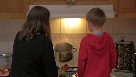 Mother-and-young-son-cooking-at-the-stove-top