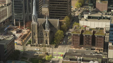 Time-lapse-from-above-of-Holy-Rosary-Cathedral-and-surrounding-intersections-of-downtown-Vancouver,-Sunny-day