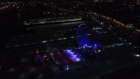 Aerial-clip-of-an-illuminated-Ferris-Wheel-in-Montreal,-Canada,-during-the-night