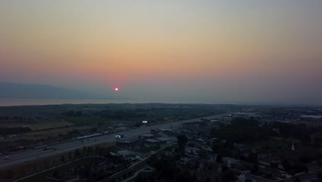 Beautiful-aerial-red-sunset-in-a-smoggy-sky-from-summer-wildfires