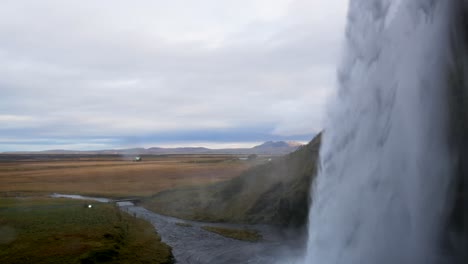 Close-Up-Shot-Parallel-with-Seljalandsfoss-Waterfall
