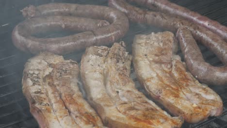 Boerewors-and-pork-on-an-outdoor-grill-in-South-Africa-close-up