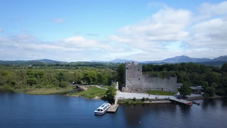 Opening-scene-close-to-the-15th-Century-Ross-Castle,part-of-Killarney-National-Park,video-moves-outward-and-rises-to-reveal-beautiful-Lakes-of-Killarney-and-distant-mountain-range,in-the-ring-of-kerry