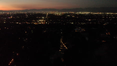 Aerial-timelapse-of-thousands-of-holiday-fireworks-exploding-above-a-busy-valley-city