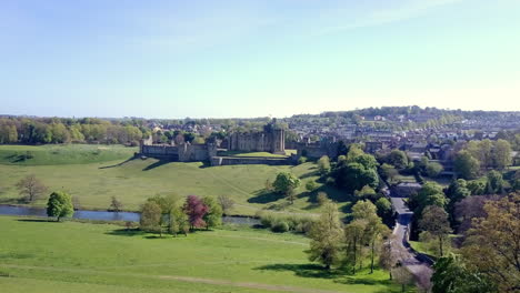 Aerial-footage-flying-towards-the-fabulous-Alnwick-Castle-in-Northumberland-UK,-famous-for-its-use-in-the-Harry-Potter-stories