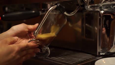 SLOWMO---Coffee-Machine-prepares-espresso-in-long-glass-coffee---CLOSE-UP