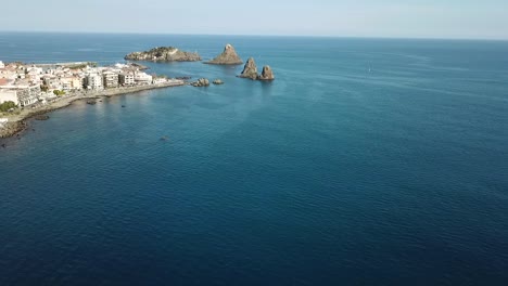 Drone-flight-along-the-coastline-near-the-cyclopean-islands,-Sicily,-Italy