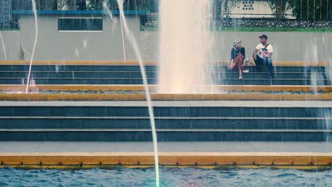 Malay-Couple-sitting-in-front-of-fountain-at-Laman-Serene-Park-in-Johor-Bahru